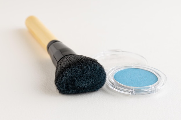 Pincel de maquillaje con sombras de ojos azules