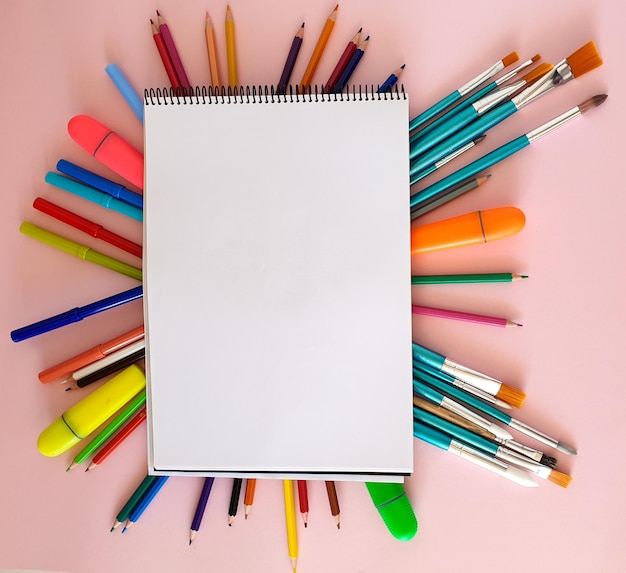 Pinceles los lápices de colores marcadores bajo el diario de pintura