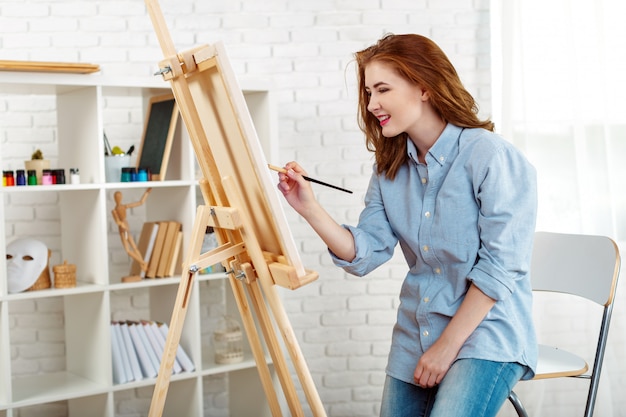 Pintor de mulher jovem e bonita no trabalho