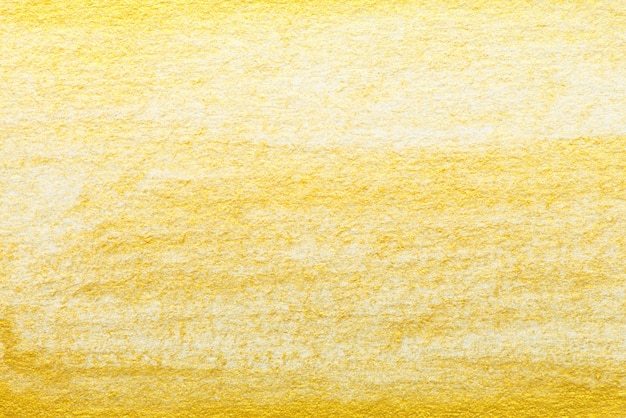 Pintura de acuarela abstracta de oro amarillo con textura sobre fondo de papel blanco