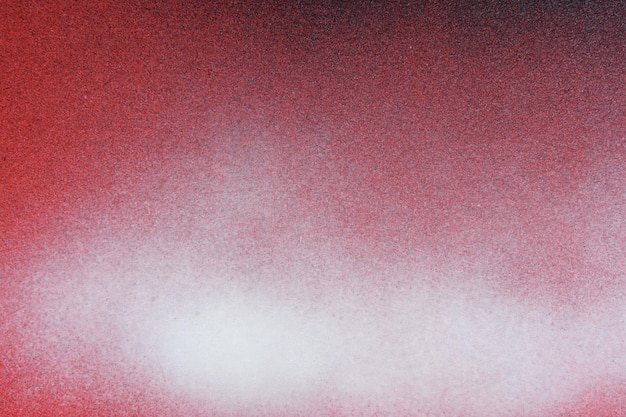 Pintura en aerosol blanca y negra sobre un fondo de papel de color rojo