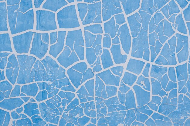 Pintura azul rachada na parede Fundo abstrato para design