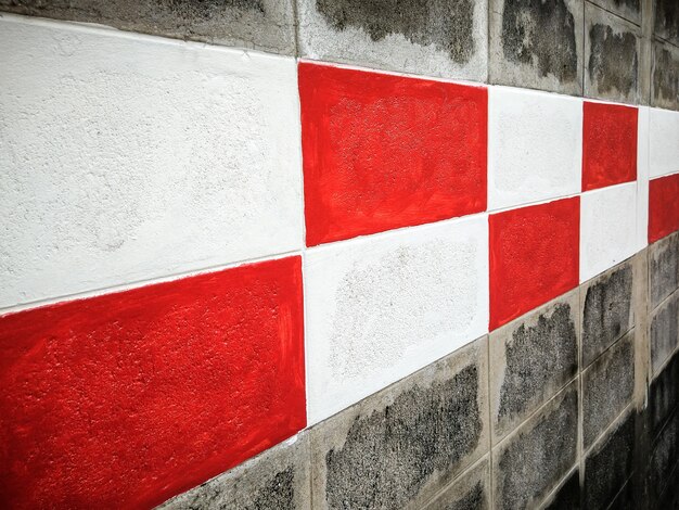 Pintura roja y blanca en la pared de ladrillo.