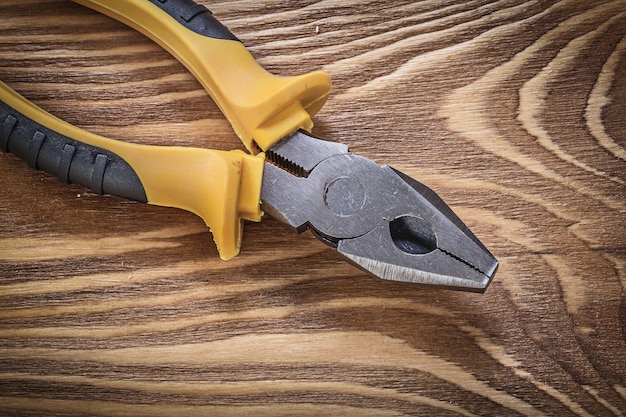 Pinzas de agarre en tablero de madera vintage directamente encima del concepto de construcción