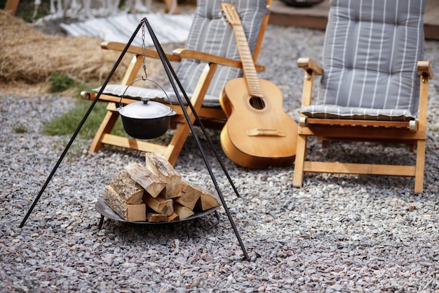 Piquenique no jardim junto ao fogo com um violão