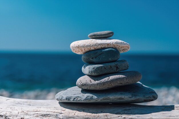 Pirámide de guijarros equilibrada en la playa en un día soleado