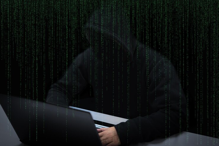 Foto pirata informático asiático en capucha negra con fondo de matriz