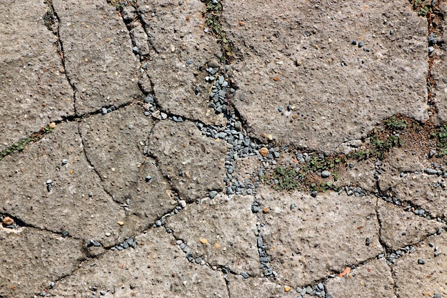 Foto piso de concreto rachado, danificado com linhas de rachadura interessantes como plano de fundo