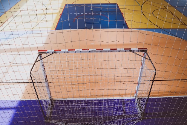 Foto piso del gimnasio y poste de la portería