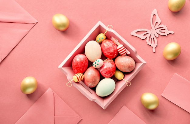 El piso de Pascua yacía sobre papel de color coral con una bandeja de madera llena de huevos decorativos, tarjetas de felicitación, sobres y flores decorativas.