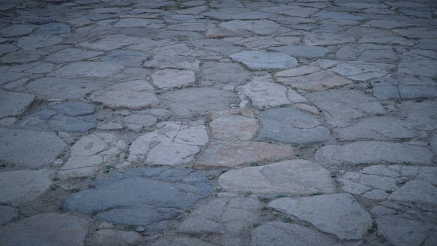 Piso de piedra con algo de polvo y piedras pequeñas en el piso