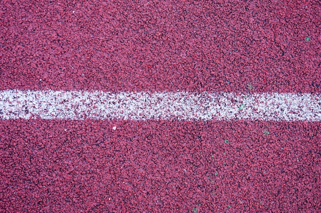 Foto pista de atletismo con textura de línea blanca textura deportiva para el fondo