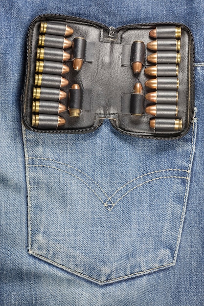 Pistola no bolso da calça jeans.