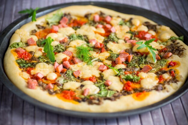 Pizza cocida con champiñones y verduras con queso y especias