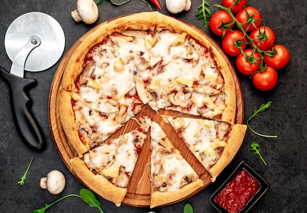 Pizza com cogumelos de frango e abacaxi em um fundo de pedra