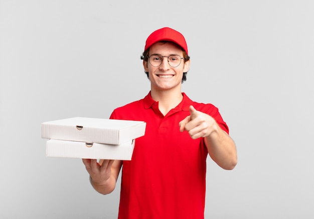 Pizza entrega niño apuntando al frente con una sonrisa satisfecha, confiada y amistosa, eligiéndote