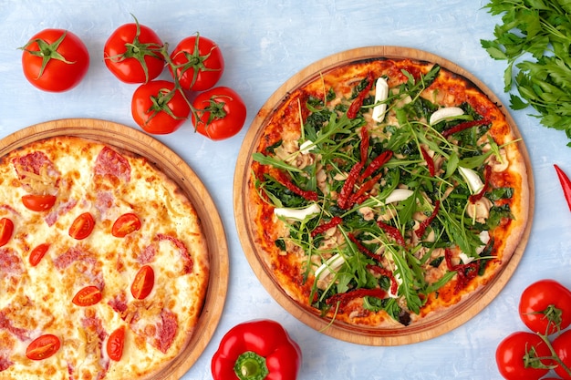 Pizza fresca com ervas e tomates secos ao sol na mesa cinza