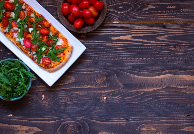 Pizza fresca de empregada doméstica com tomate, rúcula e mozzarell