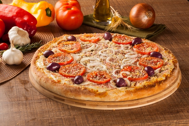 Pizza italiana tradicional con ingredientes en madera.