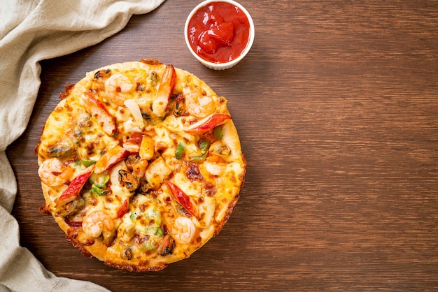 Pizza de mariscos en bandeja de madera