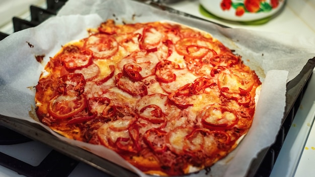 Pizza mit Fleisch, Käse und Tomaten