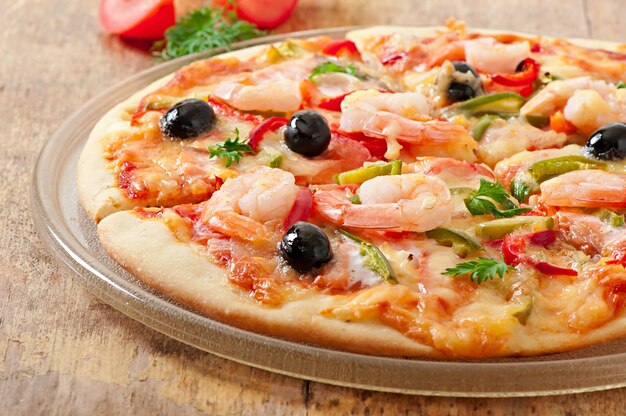 Pizza mit Garnelen, Lachs und Oliven