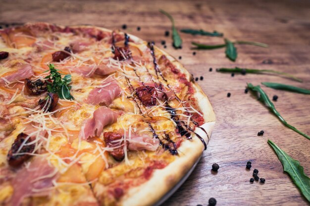 Pizza mit getrockneten Tomaten und Schinken