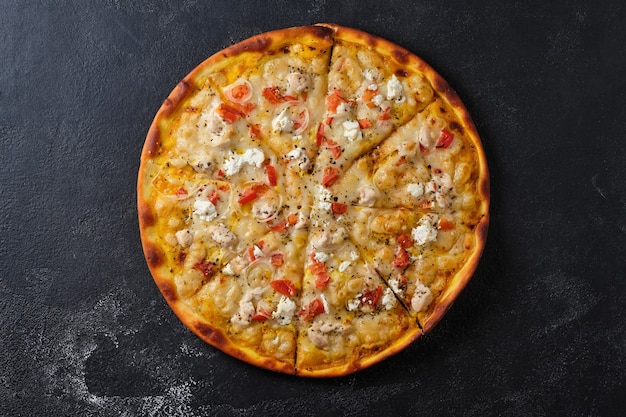 Pizza mit Tomaten Hähnchen Zwiebeln Feta Käse Mozzarella Käse und Gewürzen