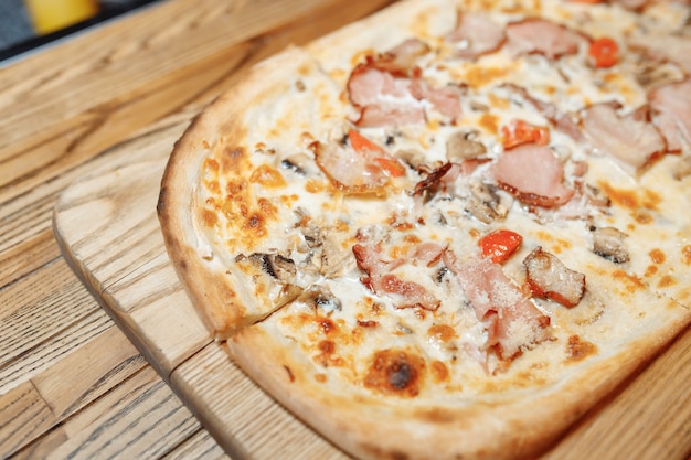 Pizza en la vista superior de la mesa de madera. Comida rápida. Publicar blogs en las redes sociales. con espacio de copia. Pizza lista para comer.
