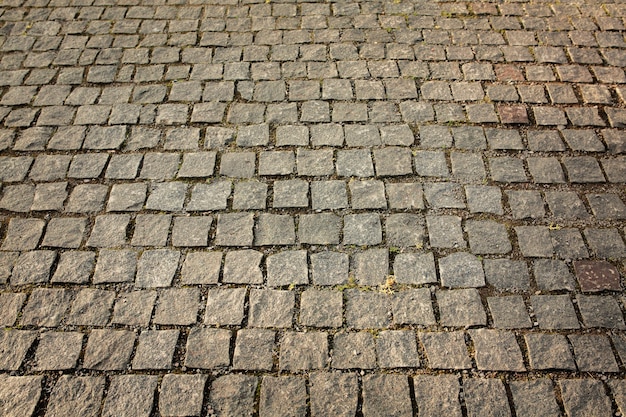 Plano de fundo de pedras de pavimentação na rua no centro da cidade de uzhgorod