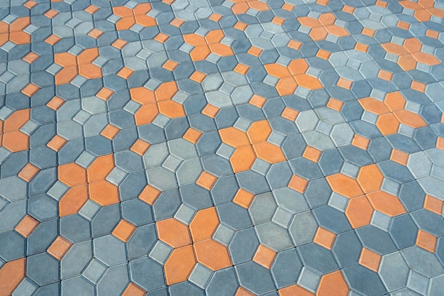 Plano de fundo padrão geométrico e textura de pavimento decorativo de paralelepípedos hexágono laranja e azul