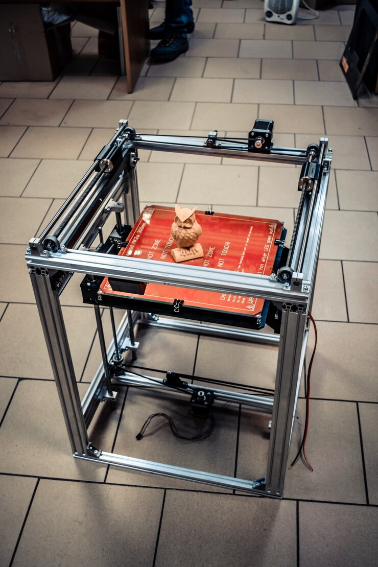 Foto plano general de impresora 3d, construcción de impresora 3d. la impresora 3d tridimensional automática realiza el modelado de colores plásticos amarillos en laboratorio.