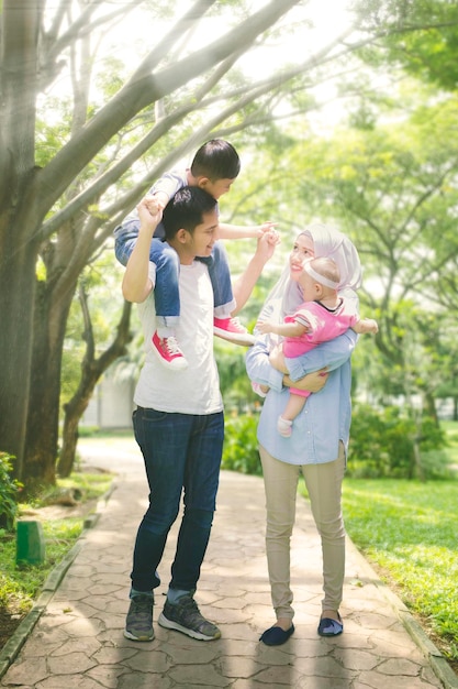 Plano medio de una familia musulmana asiática pasando la primavera juntos en el parque