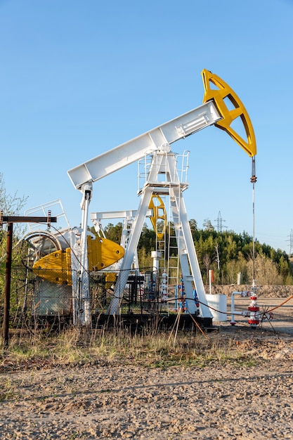 Plataforma de bomba de aceite. Producción de petróleo y gas. Sitio del campo petrolífero. Pump Jack está funcionando. Torres de perforación para la producción de combustibles fósiles y la producción de petróleo crudo. Guerra a los precios del petróleo. Crisis mundial del coronavirus COVID 19.