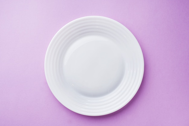 Foto plato blanco vacío en superficie rosa