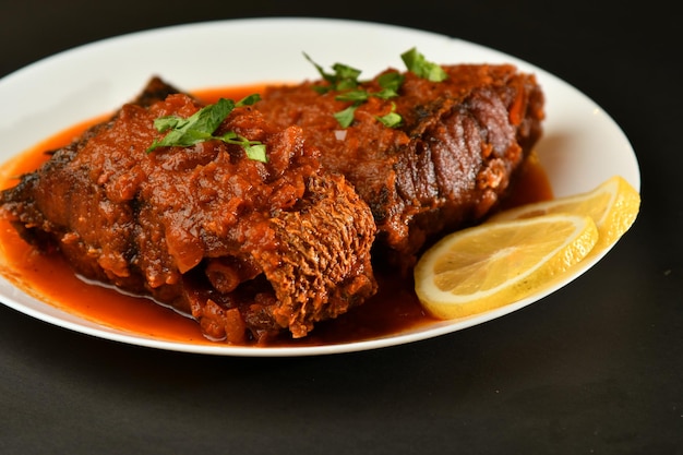 Foto un plato de comida con una rodaja de limón al lado.