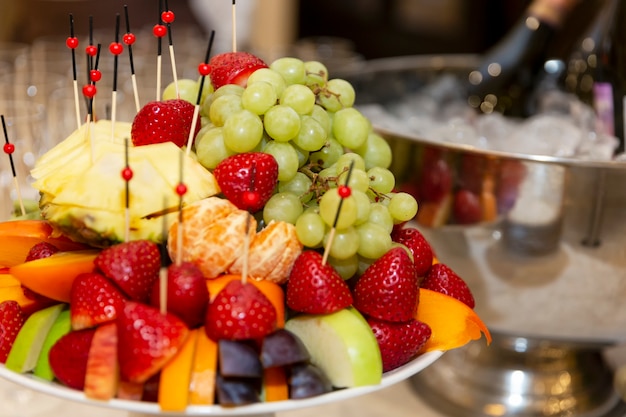 Plato de frutas apetitoso en la mesa festiva. Catering para reuniones de empresa, eventos y celebraciones.