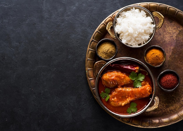 Plato indio de pollo al curry picante masala. Patas de pollo picantes con arroz