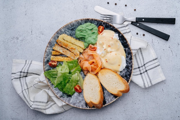 Plato con lechuga salmón palitos de pescado pan y salsas Vista superior En una servilleta