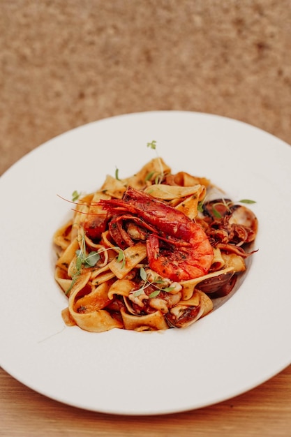 Un plato de pasta con una langosta encima