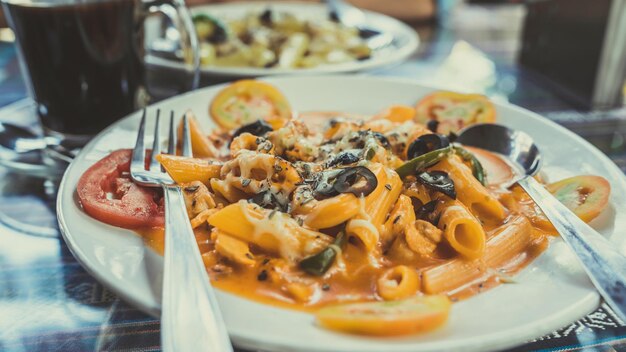 Un plato de la pasta con mariscos y verduras en salsa roja Cerrar