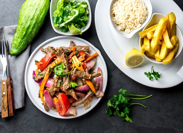 Plato peruano en una sartén con papas fritas