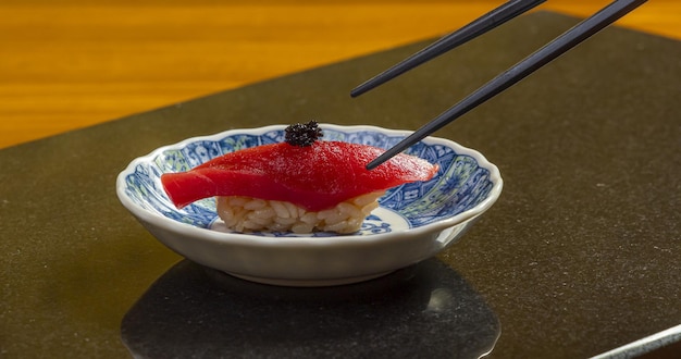 Un plato de sushi con un par de palillos