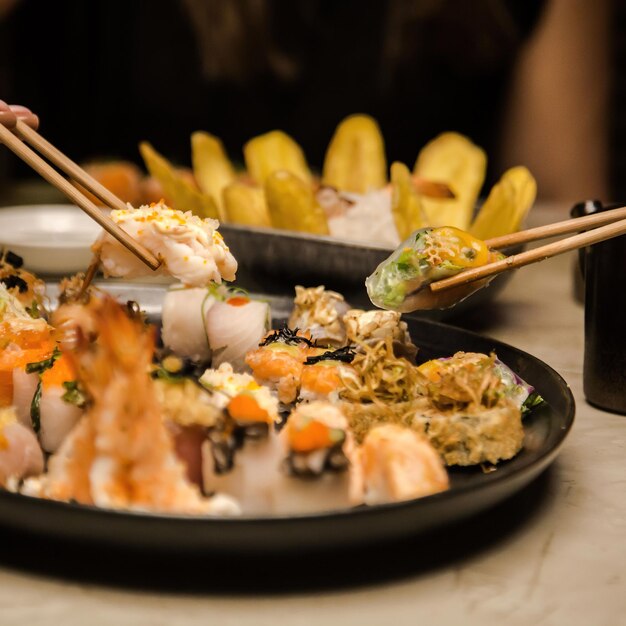 Un plato de sushi con un par de palillos