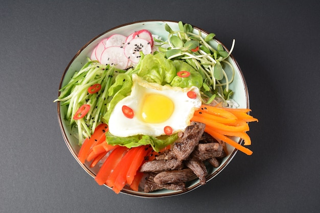 Plato tradicional coreano con huevo, carne y verduras.