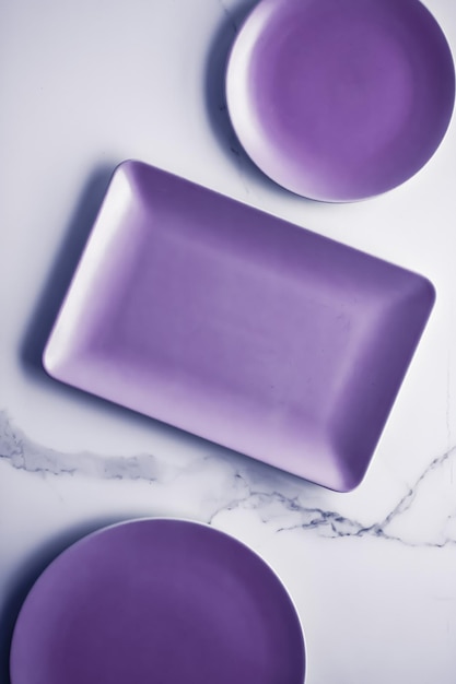 Plato vacío morado sobre fondo de mesa de mármol decoración de vajilla para el desayuno, el almuerzo y la cena para la receta del menú de la marca del restaurante diseño plano de vacaciones de lujo