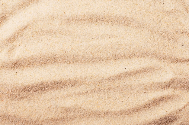 Foto playa de arena de telón de fondo junto al mar. textura de arena.
