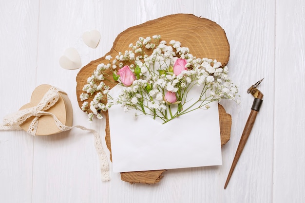 Pluma caligráfica un sobre con flores y una carta