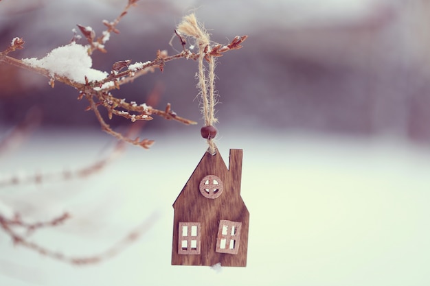 Época de Natal. Casinha de madeira em um galho no inverno e neve