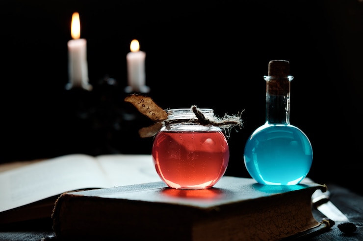 Foto pociones y velas en un libro